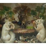 A late Victorian cased taxidermy of four red squirrels playing cards,