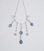 A sapphire and diamond fringe necklace, the graduated drops set with four cabochon sapphires,