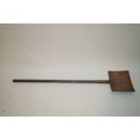 An early 20th century butter paddle, with ash handle and pierced copper head,