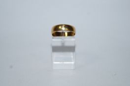 A 22 carat gold wedding ring, Birmingham 1899, of shallow D section, 5mm wide,