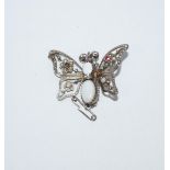 A silver coloured butterfly brooch, set with opal, pastes and seed pearls,
