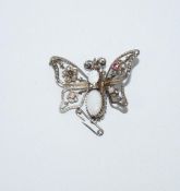 A silver coloured butterfly brooch, set with opal, pastes and seed pearls,