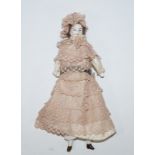 A late 19th century German bisque porcelain and fabric miniature doll,