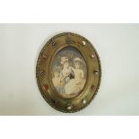 A late 19th century tinted photographic portrait of three young girls, in oval gilt brass frame,