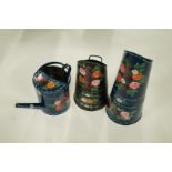 A bargeware watering can by Alison Cockerell, painted with flowers on a blue ground,