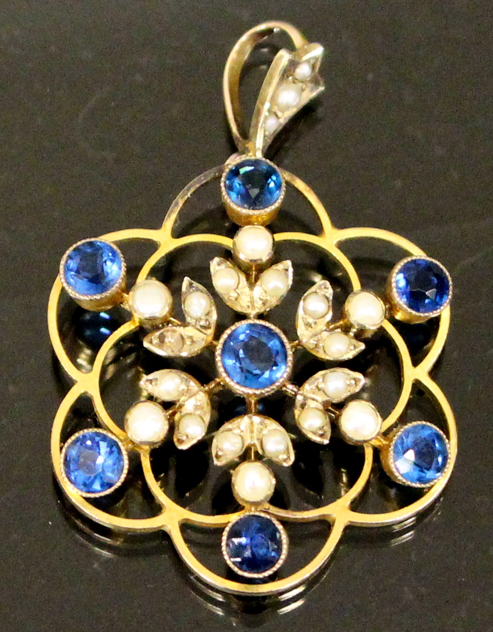 A 9ct gold pendant decorated with seed p