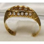 An 18ct gold ring set with 5 small diamo