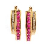 Pair of Ruby, Diamond, 10k Yellow Gold Earrings. Each features nine round-cut rubies and nine