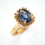 Sapphire, Diamond, 14k Yellow Gold Ring. Centering one oval-cut sapphire weighing approximately 1.65