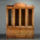 Massive Aesthetic Movement Two Piece Oak Bookcase, with carved door trophy panels symbolic of