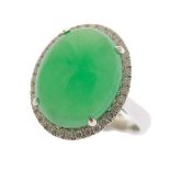 Jade, Diamond, 14k White Gold Ring. Centering one oval jadeite cabochon measuring approximately 15 x