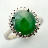 Jade, Diamond, 18k White Gold Ring. Centering one jadeite cabochon measuring approximately 11.04 x