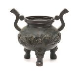 A Bronze Tripod Censer  The censer cast with opposing dragons centering a flaming pearl  amidst