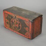 A Tibetan Painted Wood Chest With hinged top, painted with cloud patterns surrounding a figural