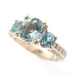 Blue Topaz, Diamond, Platinum Ring. Centering one round-cut blue topaz weighing approximately 2.00