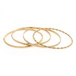 Collection of Four 14k Yellow Gold Bracelets. Including one 14k yellow gold, hammered texture, 3