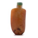 A Russet Jade Snuff Bottle, 19th Century   A Russet Jade Snuff Bottle The well-hollowed bottle is of