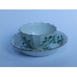 A Dr Wall period Worcester porcelain fluted tea bowl & saucer, painted green floral sprays on white,