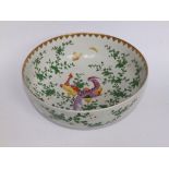 A 19thC Chinese porcelain punch bowl, painted in famille rose European taste ,depicting exotic