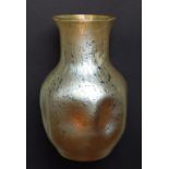 A Loetz iridescent amber glass vase with dimpled body, unsigned,  circa 1900,  8.25”