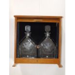 A pair of Orrefors heraldic decanters –'1962-1982', 'RB' & 'MB' to stoppers, 11” in oak tambour case