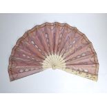 A 19thC Cantonese carved ivory fan, the pink silk leaf applied with silver sequins & lace, 13”