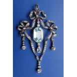 An aquamarine & diamond pendant, formed as three diamond set bows with two central aquamarine swings