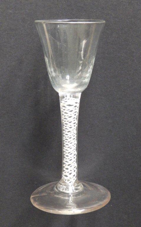 An 18thC wine glass with fluted round funnel bowl on double series opaque twist stem to plain