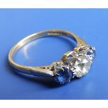 A three stone diamond & sapphire ring, the central old cut diamond approximately .75 carat