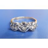 A three stone diamond ring, the central  old cut brilliant weighing approximately .75 carat in white