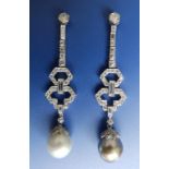 A pair of art deco style diamond set pearl drop earrings in platinum coloured metal – a white