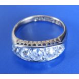 A five stone graduated diamond ring, the central old cut stone weighing approximately .50 carat in