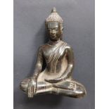 A small antique iron Tibetan seated Buddha, 7.5”