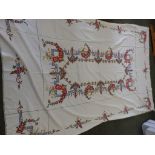 A table cloth embroidered in tapestry style