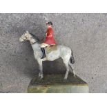 A cold painted metal huntsman on horseback