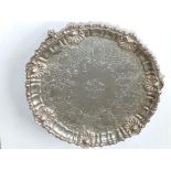 A George IV silver salver, cast shells to the scrolling border, coat of arms to centre – 'PROGEDIOR'