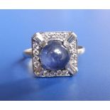 A cabochon sapphire & diamond square cluster ring in white metal