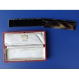 A cased Cartier black enamelled & gilt metal folding comb, 8.1” overall