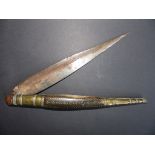 A Spanish Navaja folding knife, the horn handle with brass inlay, 18.5” overall