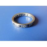 A diamond & sapphire set platinum eternity ring