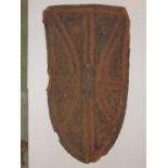 A 19thC African hide shield of arched form, 35”