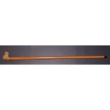 A Victorian malacca walking stick with carved dog's head handle, inset eyes,  36”