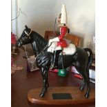 A Beswick Lifeguard Style 2 equestrian figure on wooden base