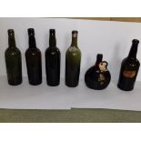 Six antique wine bottles