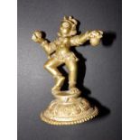 A gilt brass Indian figure of a dancing god, 6”