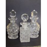 A pair of cut glass scent bottles and one other (3)