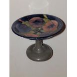 A Liberty Tudric Moorcroft Pansy pattern tazza on  beaten pewter stand, 7.5” diameter – stand bent