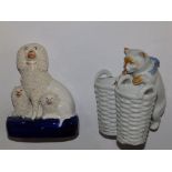 A small Staffordshire spaniel group and a continental cat and basket double vase  (2)