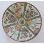 A 19thC Cantonese porcelain charger, painted with typical famille rose panel decoration depicting