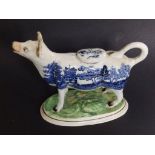 A Victorian willow pattern cow creamer – tail re-stuck, 7” across